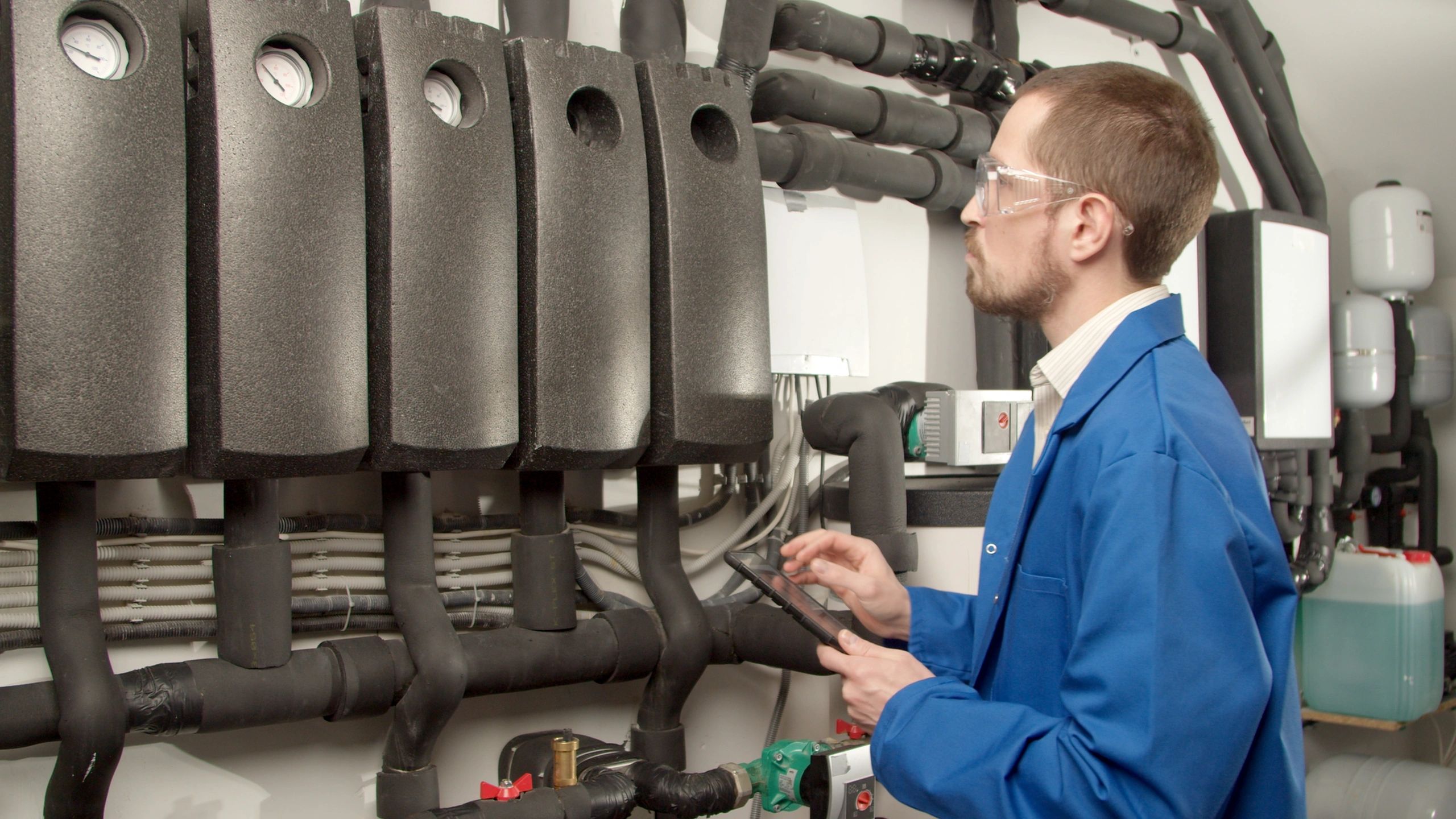 Technician checking plumbing system gauges
