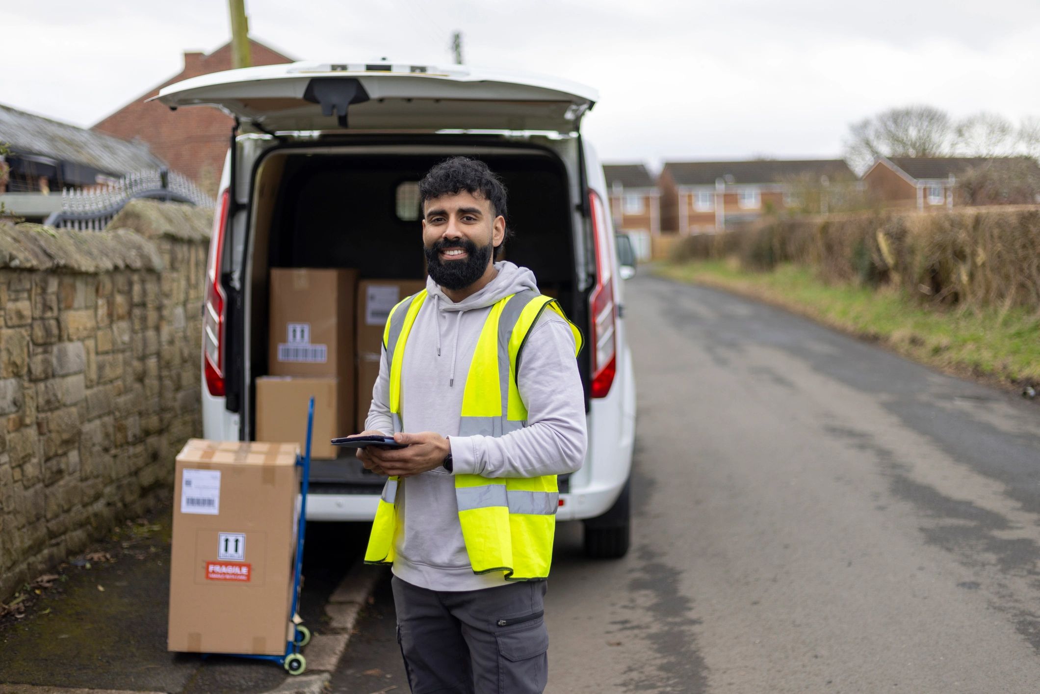 Service professional standing in front of a work van